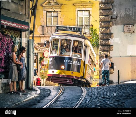 Lisbon. Famous old tram climbing uphill in Alfama Stock Photo - Alamy