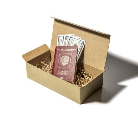 Hundred Dollar Bills Enclosed In A Foreign Passport Lie In A Cardboard