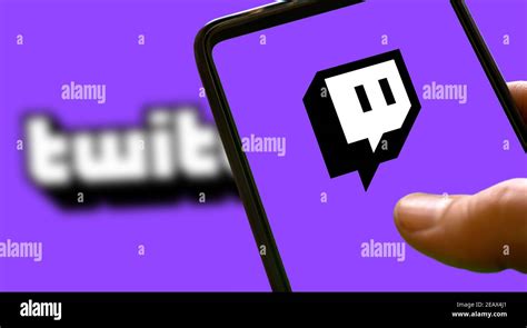 Purple twitch logo on a smartphone screen with purple background and ...