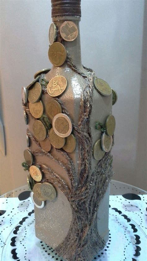 A Bottle That Has Some Coins In It And Is On Top Of A Doily