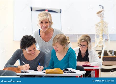 Science Class with Teacher and Three Female Students Stock Image ...