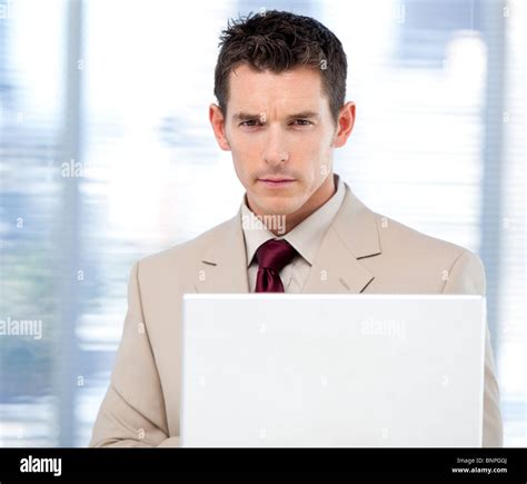 Self Assured Businessman Using A Laptop Standing Stock Photo Alamy