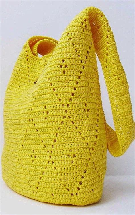 A Yellow Crocheted Bag With A Long Handle On The Front And Side