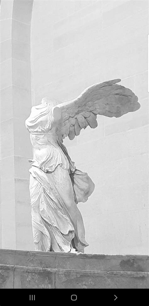 An Angel Statue On The Side Of A Building