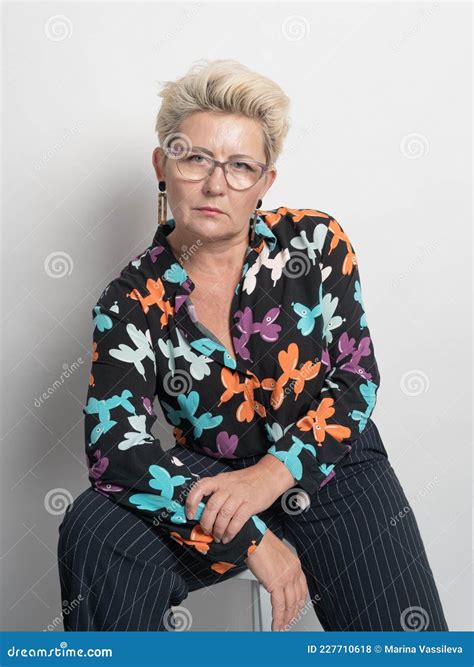 Adult Woman With Short Hair Blonde With Glasses Posing At The Camera