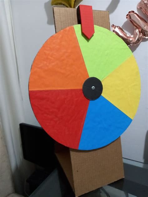 A Cardboard Toy With A Colorful Wheel On It