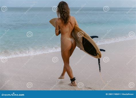 Behind Of Naked Woman With Perfect Body With Surfboard On Beach With