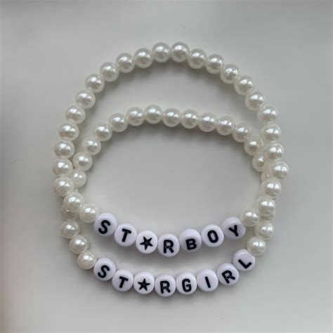 Two Bracelets With White Beads And Letters That Spell Out The Word Starboy