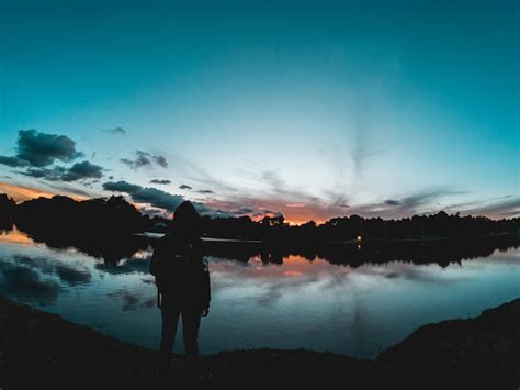 Silueta De Un Hombre Mirando La Puesta De Sol Foto Premium