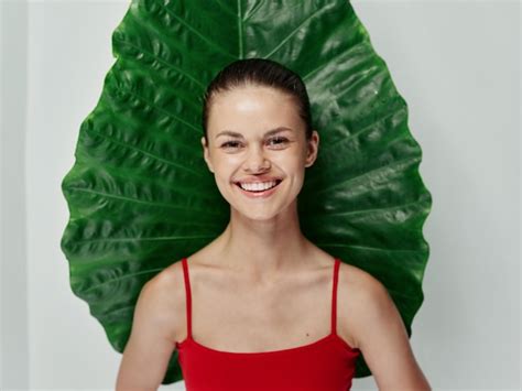 Premium Photo Woman In A Red Swimsuit Smile Green Leaf Exotic Light