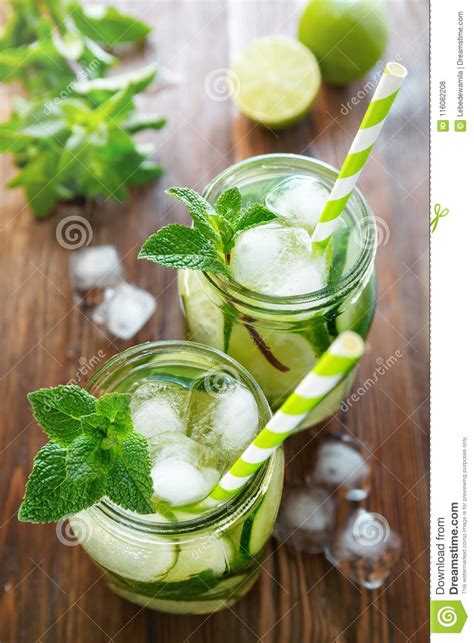 Two Jars Of Detox Water With Cucumber Lime And Ice Pieces Decorated