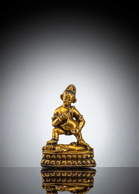 At Auction A GILT BRONZE FIGURE OF JAMBHALA