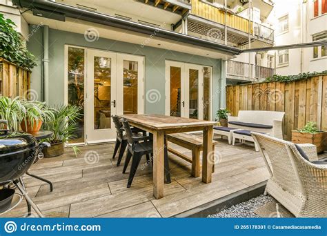 A Patio with a Wooden Table and Chairs Stock Image - Image of modern ...