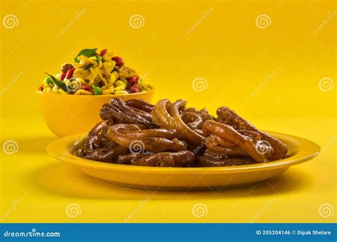 Jalebi And Traditional Indian Deep Fried Salty Dish Called Chivda Or Mixture Or Farsan Stock