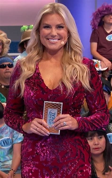 A Woman In A Red Dress Is Smiling And Posing For The Camera With Other