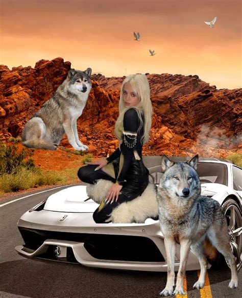 A Woman Sitting On Top Of A Car With Two Wolfs In Front Of Her