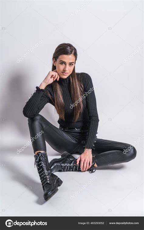 Luscious Brunette In Black Clothes Posing In Studio Against White Background Stock Photo By