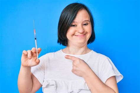 Brunette Woman With Down Syndrome Holding Syringe Smiling Happy
