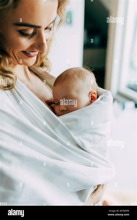 Pretty Mom Holding Her New Born Son And Smiling Stock Photo Alamy