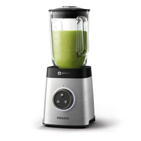 A Blender Filled With Green Smoothie Sitting On Top Of A White Countertop