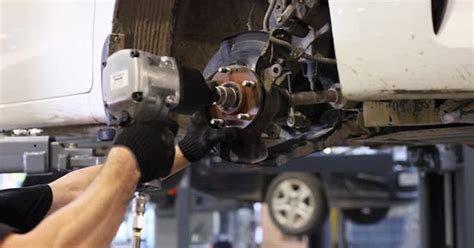 Auto Mechanic Installing Car Front Brake Caliper And Brake Pads