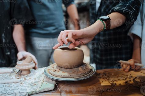 Making a handmade clay pot in the workshop. Pottery lesson with master ...