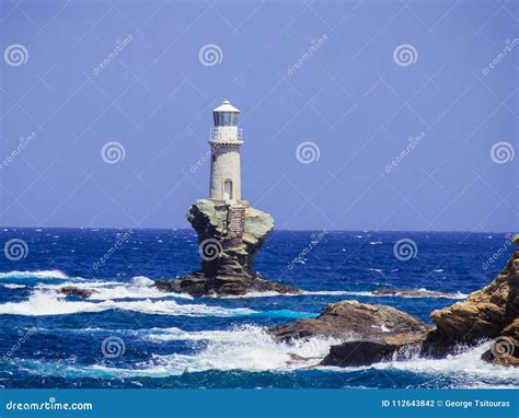 The White Lighthouse Of Andros Island In The Cyclades Greece Stock