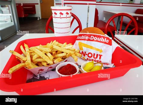 In N Out Burger Double Double Burger And French Fries In A Tray On The Table Inside The Fast