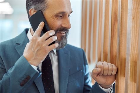 Premium Photo Adult Businessman Using Smartphone In A Modern Office