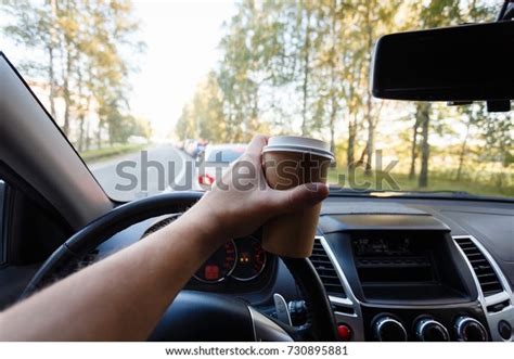 The Driver Is Drinking Coffee Behind The Wheel Closeup Transportation