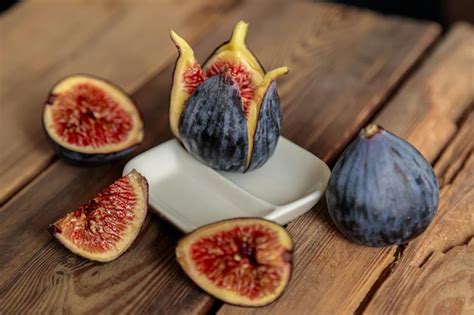 Premium Photo Fresh Cut Purple Figs On A Wooden Background From Old