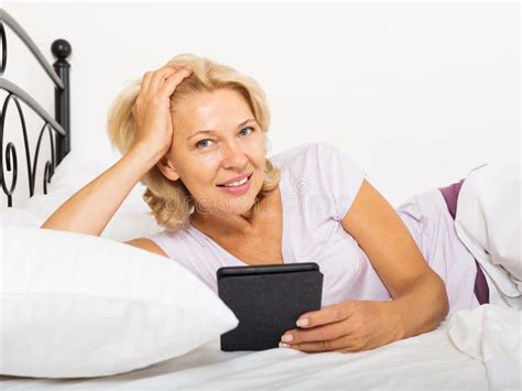 Happy Mature Woman With Electronic Book Stock Image Image Of House