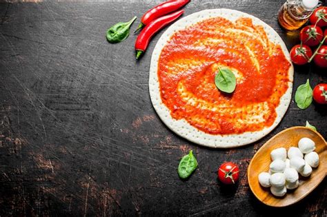 Premium Photo Preparation Pizza Rolled Out Dough With Tomato Paste