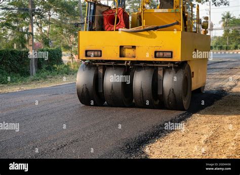 Heavy Vibration Yellow Steamroller Or Soil Compactor Working On Hot Mix