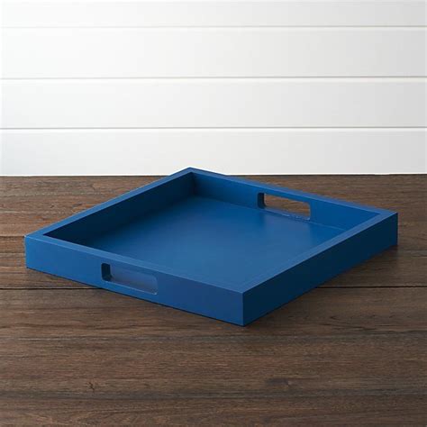 A Blue Tray Sitting On Top Of A Wooden Floor Next To A White Wall And