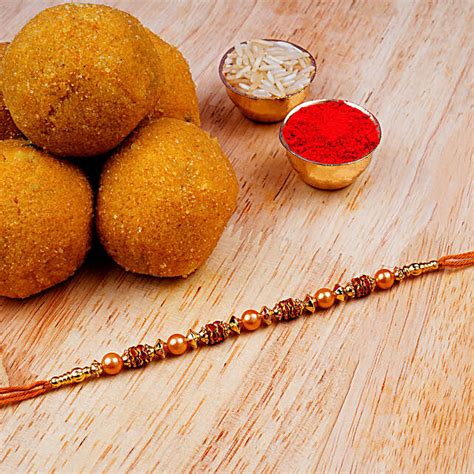 Golden Red Thread Rakhi And Besan Laddoo Singapore Gift Golden Red