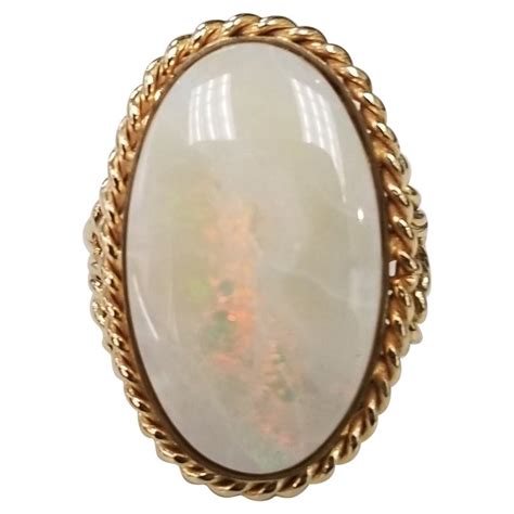 This Beautiful Vintage 14k Yellow Gold Fiery Oval Opal Ring For Sale at 1stDibs