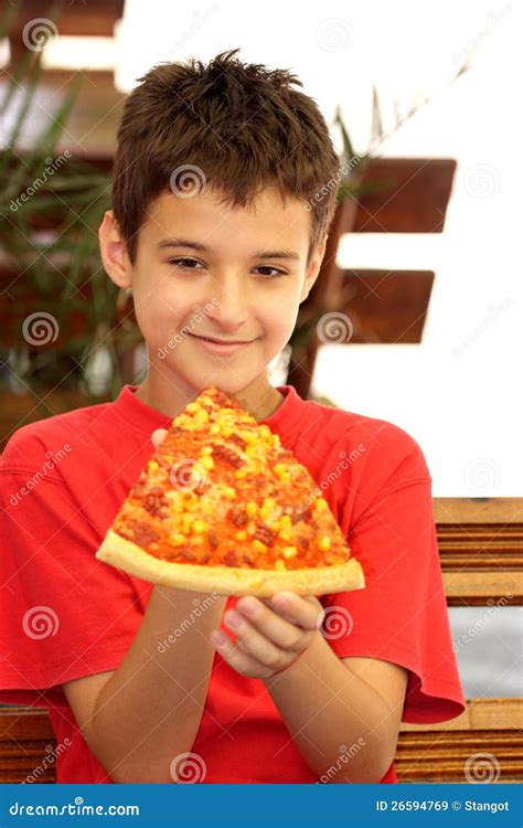 A boy eating pizza stock image. Image of hold, person - 26594769