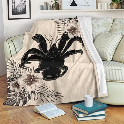 A Blanket With A Black Spider On It Sitting On Top Of A Wooden Floor