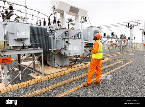 Professional African Electrician Working In Electrical Substation Stock