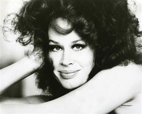 A Black And White Photo Of A Woman With Long Curly Hair Posing For The