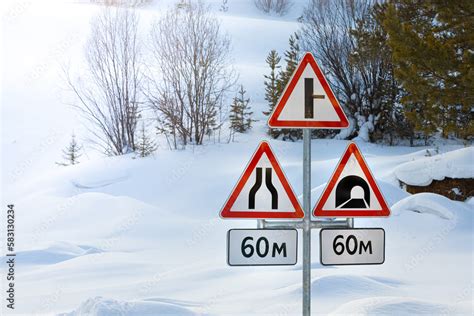 Rack with three road signs and information boards against the ...