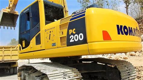 Komatsu PC200 8 Excavator Loading Limestone Into Dump Truck On Road