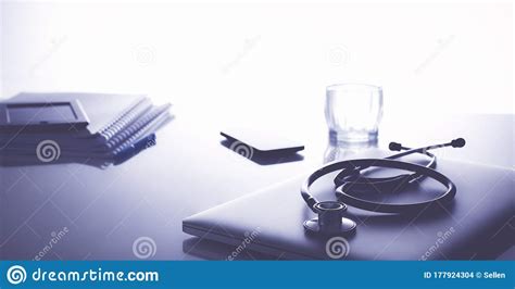 Workplace Of Doctor With Laptop And Stethoscope And Notebook Stock