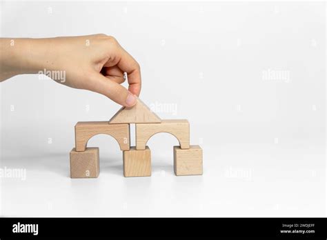 building wood blocks on white background; business or creative concept ...