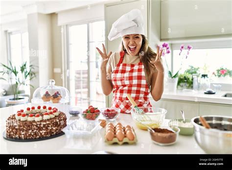 Beautiful Young Brunette Pastry Chef Woman Cooking Pastries At The Kitchen Celebrating Crazy And