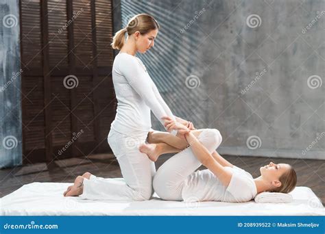 Young Woman Is Getting Thai Massage Treatment By Therapist Traditional