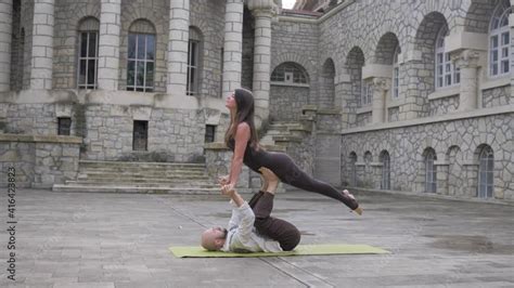 Acrobatic Yoga For Couples Pose Of Asana Airplane With A Jump Yoga Pose For Two Men And