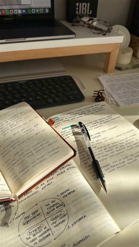 An Open Book Sitting On Top Of A Desk Next To A Laptop Computer