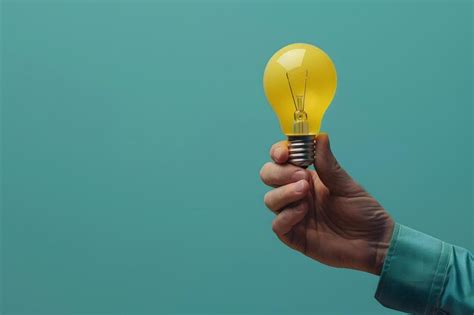 Person Holding Light Bulb On Blue Background Premium Ai Generated Image